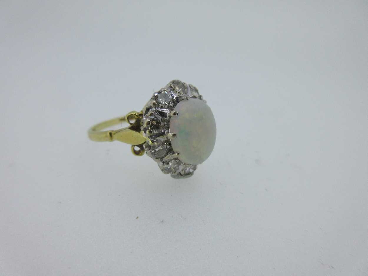 An opal and diamond cluster ring set in hallmarked gold, - Image 2 of 6