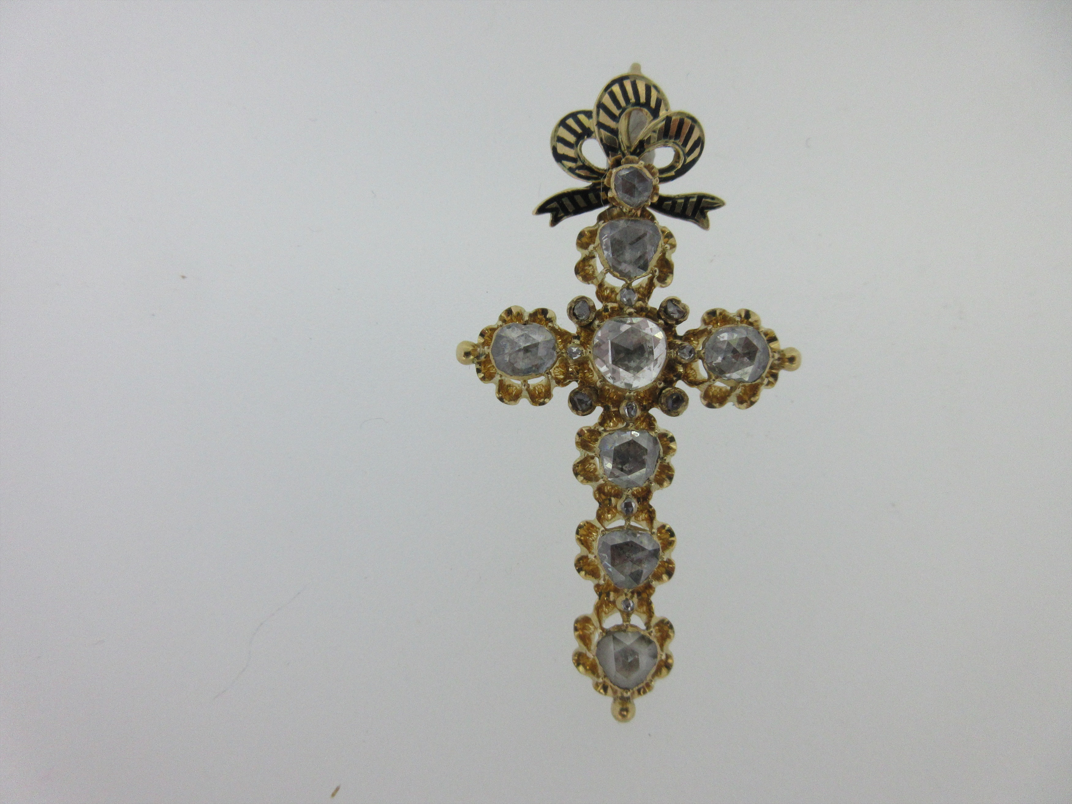 A Continental diamond set cross with enamel and diamond pendant bale,