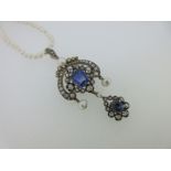 A late 19th century sapphire, diamond and pearl pendant on a string of seed pearls,