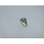 A diamond flowerhead cluster ring,