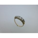 A five stone diamond ring in carved head mount,