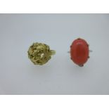 A modern foliate boss ring testing for 18ct gold and a coral ring,