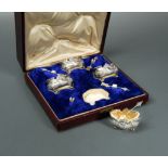 A late 19th century French metalwares cased set of four silver salts with spoons,