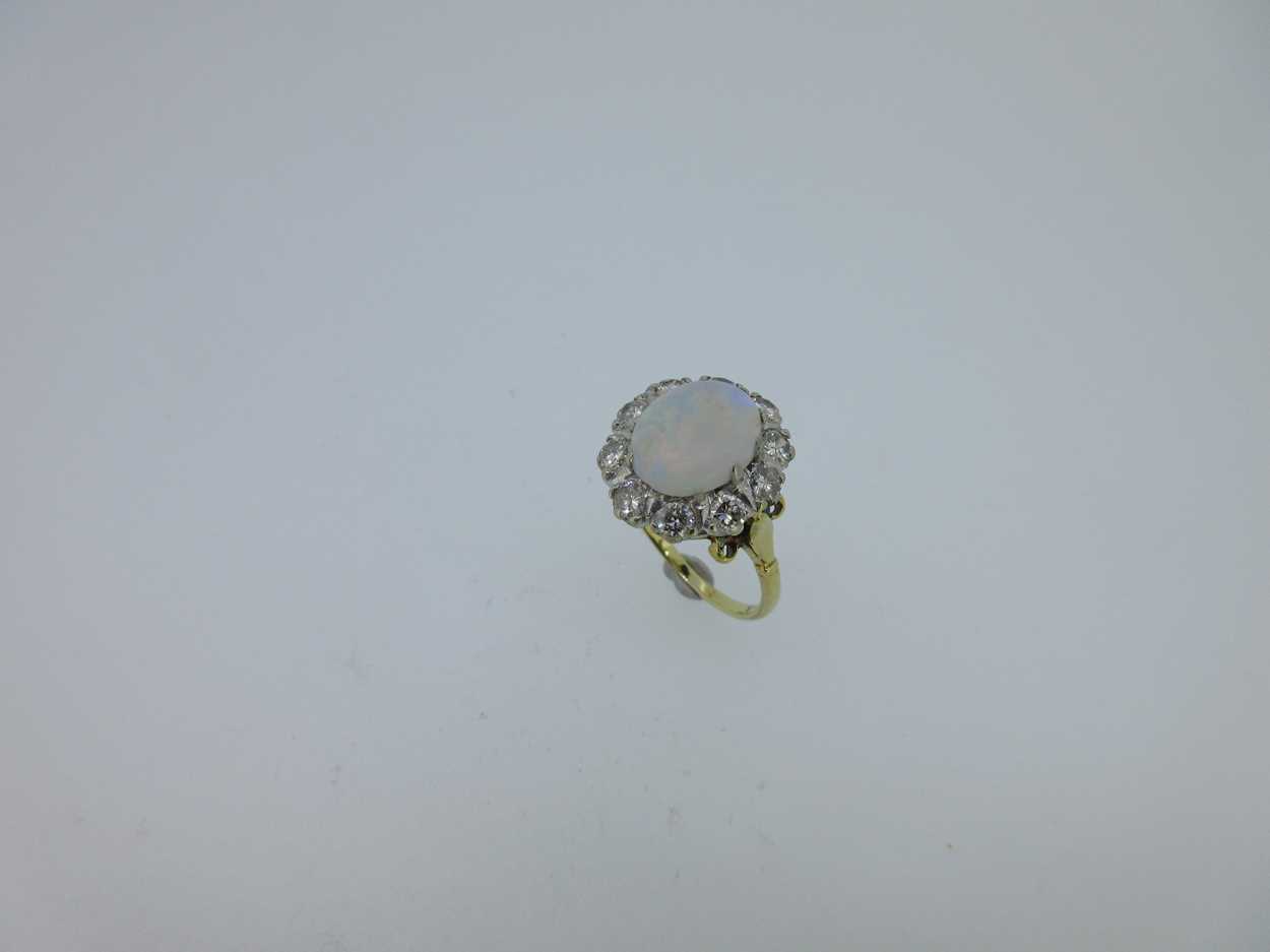 An opal and diamond cluster ring set in hallmarked gold, - Image 6 of 6