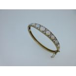 An opal and diamond hinged bangle,