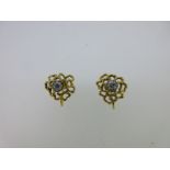 A pair of gold and diamond screw back earrings,