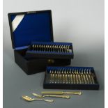 A canteen containing a 54 piece set of German silver gilt metalwares dessert cutlery and flatware,