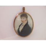 A portrait miniature attributed to Adam Buck, mounted in a pendant with hairwork reverse,