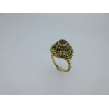 An Eastern style ruby and turquoise ring,