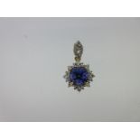 A tanzanite and diamond cluster pendant set in 18ct gold,