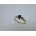 A ruby and diamond three stone ring,