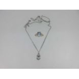 An aquamarine and diamond pendant together with a similarly set ring,