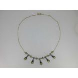 A peridot and diamond fringe necklace,