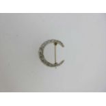 A diamond closed crescent brooch,