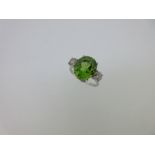 A peridot and diamond three stone ring,