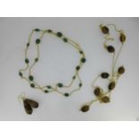 A green hardstone set chain necklace and a similar tiger's eye necklace with matched ear pendants,