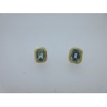 A pair of 18ct gold and blue topaz earstuds,