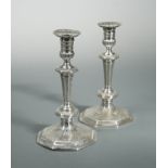 A pair of Queen Anne Britannia silver cast candlesticks,