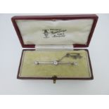A diamond bar brooch in fitted case,