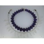 A necklace of carved amethyst beads and another of carved rock crystal leaves,