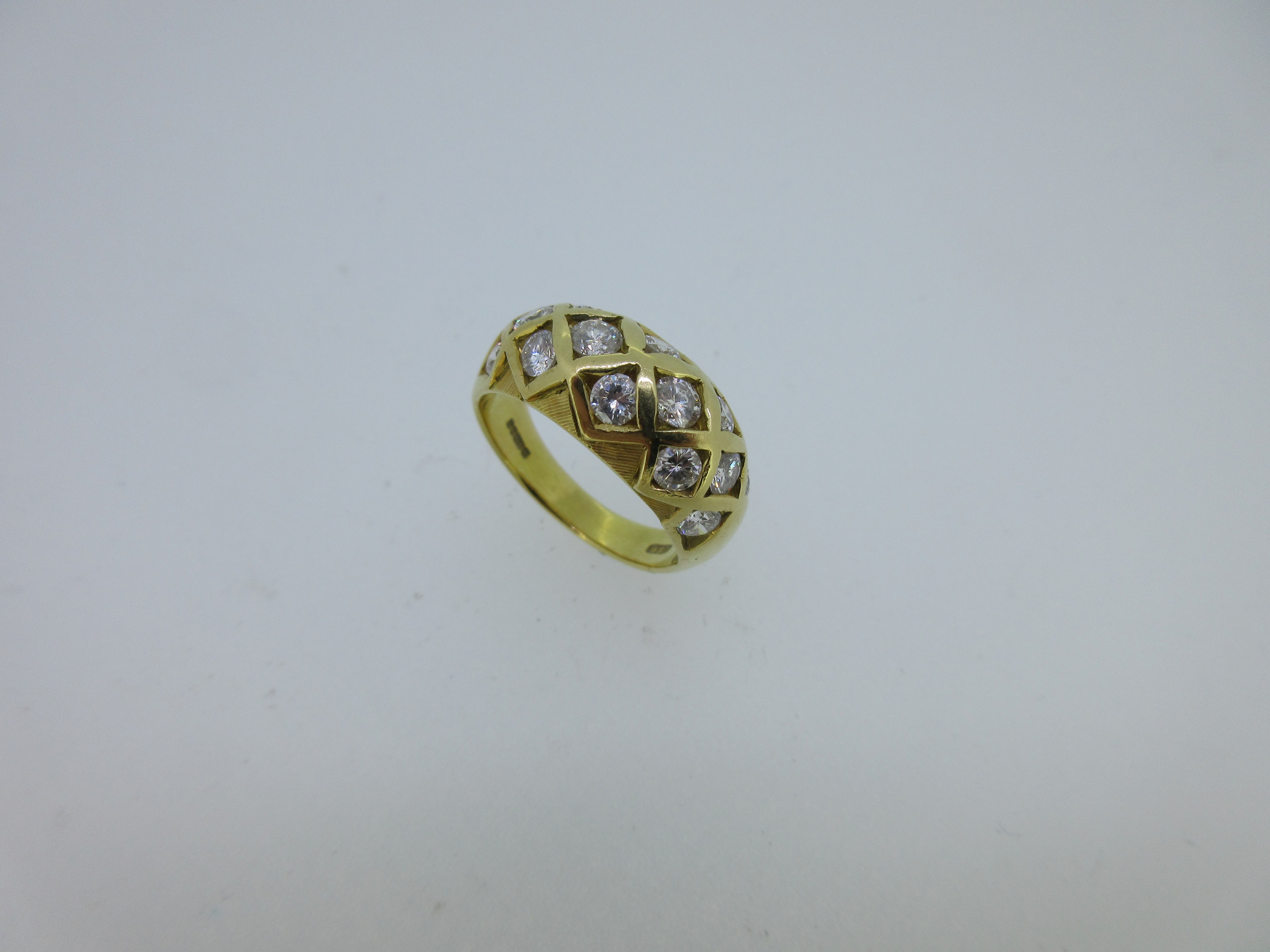 An 18ct gold and diamond set chequerboard bombé ring,