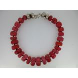 A vintage necklace of large coral beads with double bun white metal beads,