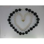 A row of uniform pearls together with a banded agate necklace,