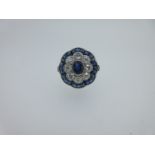 A sapphire and diamond flower head ring,