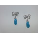 A pair of diamond and turquoise bow and drop earpendants,