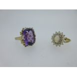 An amethyst and diamond statement ring together with an opal and diamond cluster ring,
