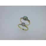 A single stone diamond ring together with an opal and diamond cluster ring,