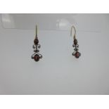 A pair of garnet and diamond earpendants,