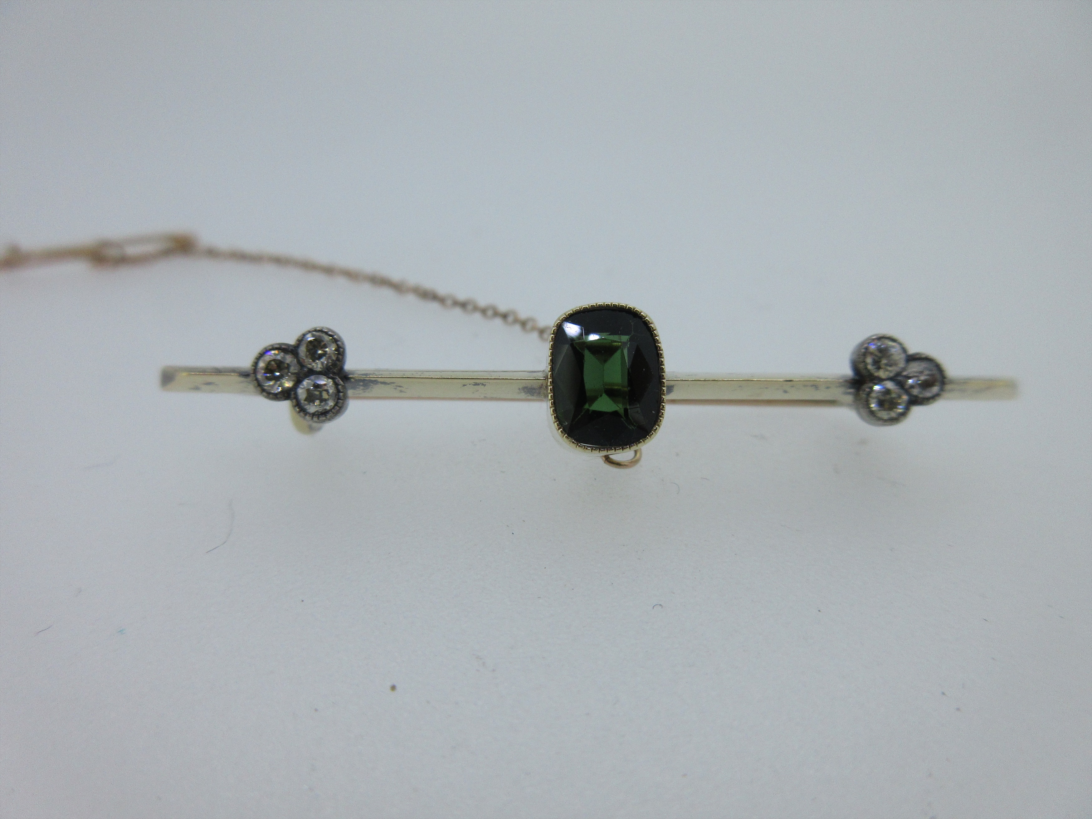 A green tourmaline and diamond bar brooch,