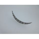 A diamond open crescent brooch,