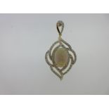 A contemporary opal, diamond and 18ct gold pendant,