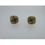 A pair of 18ct gold knot earstuds with sapphire centres,