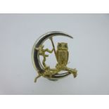 A bi-coloured gold owl and crescent moon brooch by Alabaster & Wilson,