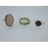 An 18ct bi-coloured band ring and two gemset rings,