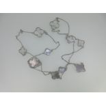 A chain necklace with mother of pearl quatrefoils,