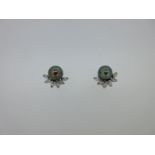 A pair of Tahitian pearl and diamond earclips,
