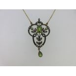 An Edwardian style peridot, seed pearl and diamond pendant necklace,