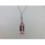 A morganite and diamond pendant on chain,