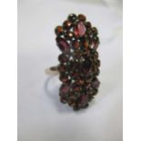 A garnet set plaque ring