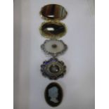 A collection of four stone plaque brooches together with a cameo brooch (5)