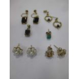 A collection of four pairs of earrings variously set with garnets, cultured pearls, sapphires and