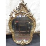 A 19th century gilt framed looking glass of rococo cartouche outline 98 x 55cm