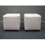 A pair of cream leather stools