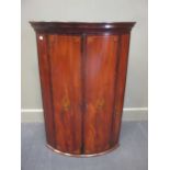 George III inlaid mahogany bow front corner cupboard with key