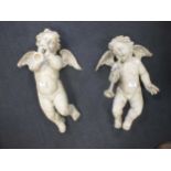 A pair of 20th century Italian style pattern cherubs playing pipes, 52 cm high