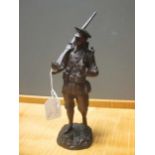 A bronze model of a WWI soldier with rifle sloped, signed H. Tremo, 26cm high